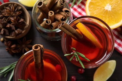 Photo of Aromatic punch drink and ingredients on wooden table, flat lay