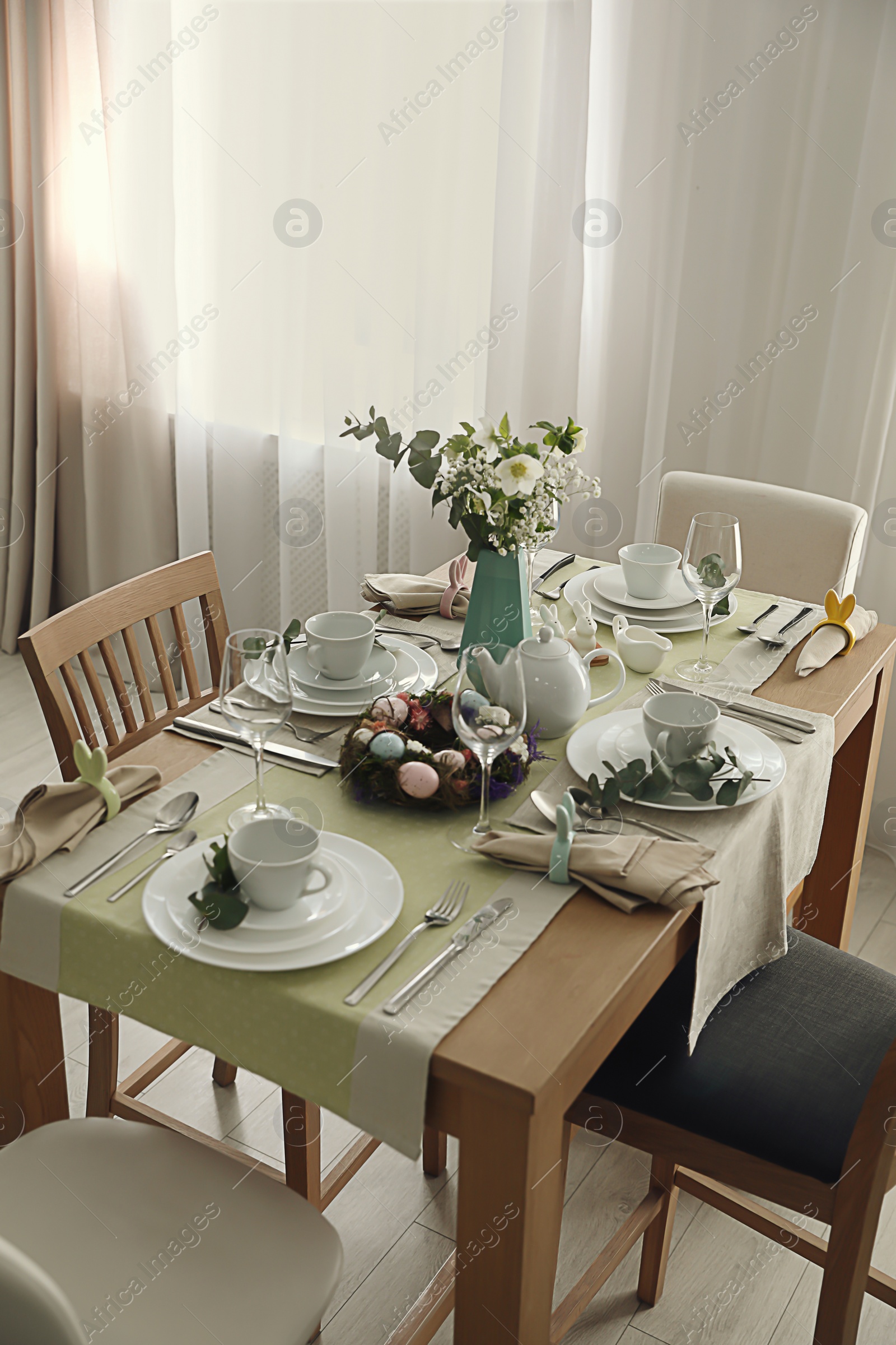 Photo of Beautiful Easter table setting with festive decor indoors