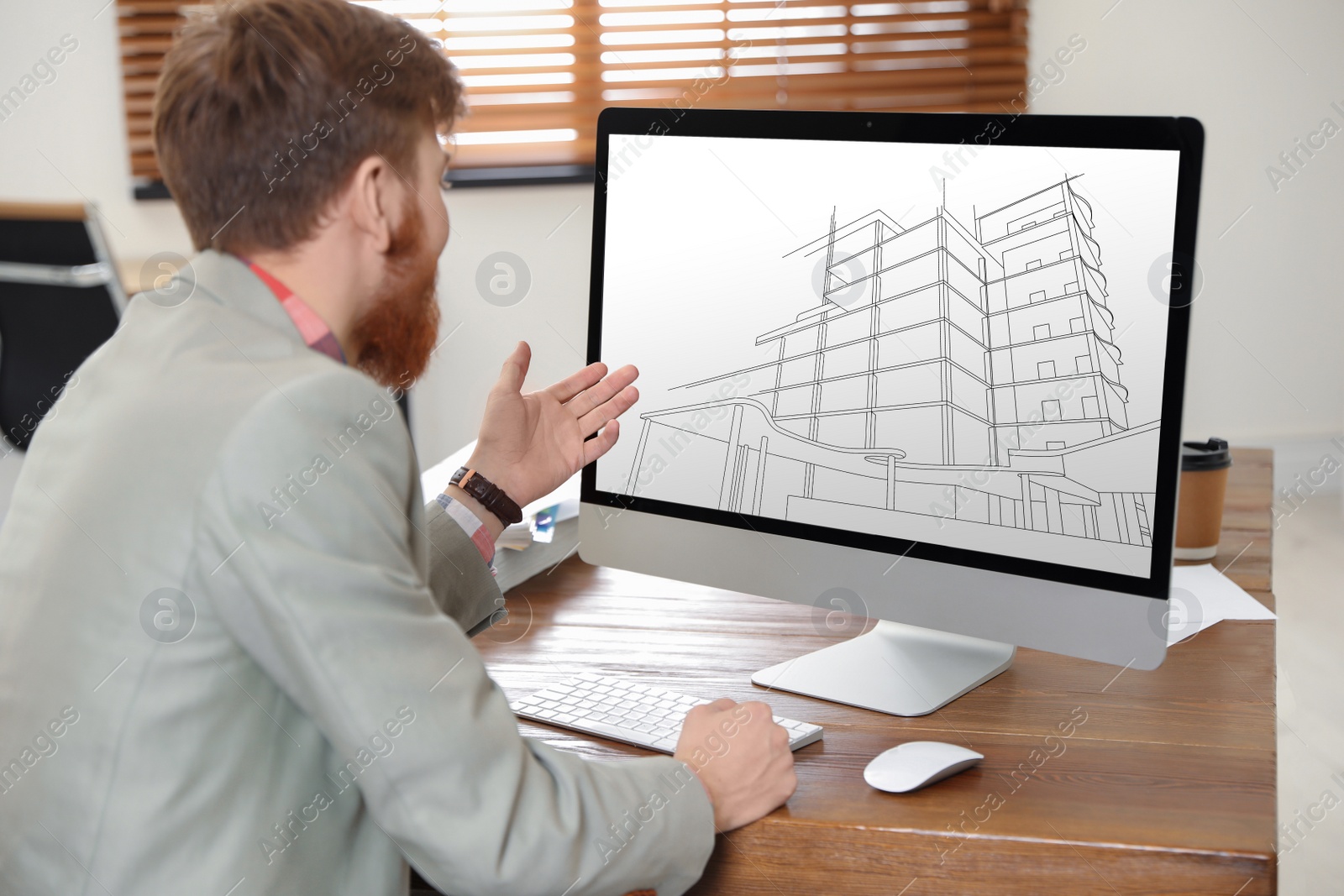 Image of Architect making project of house on computer in office