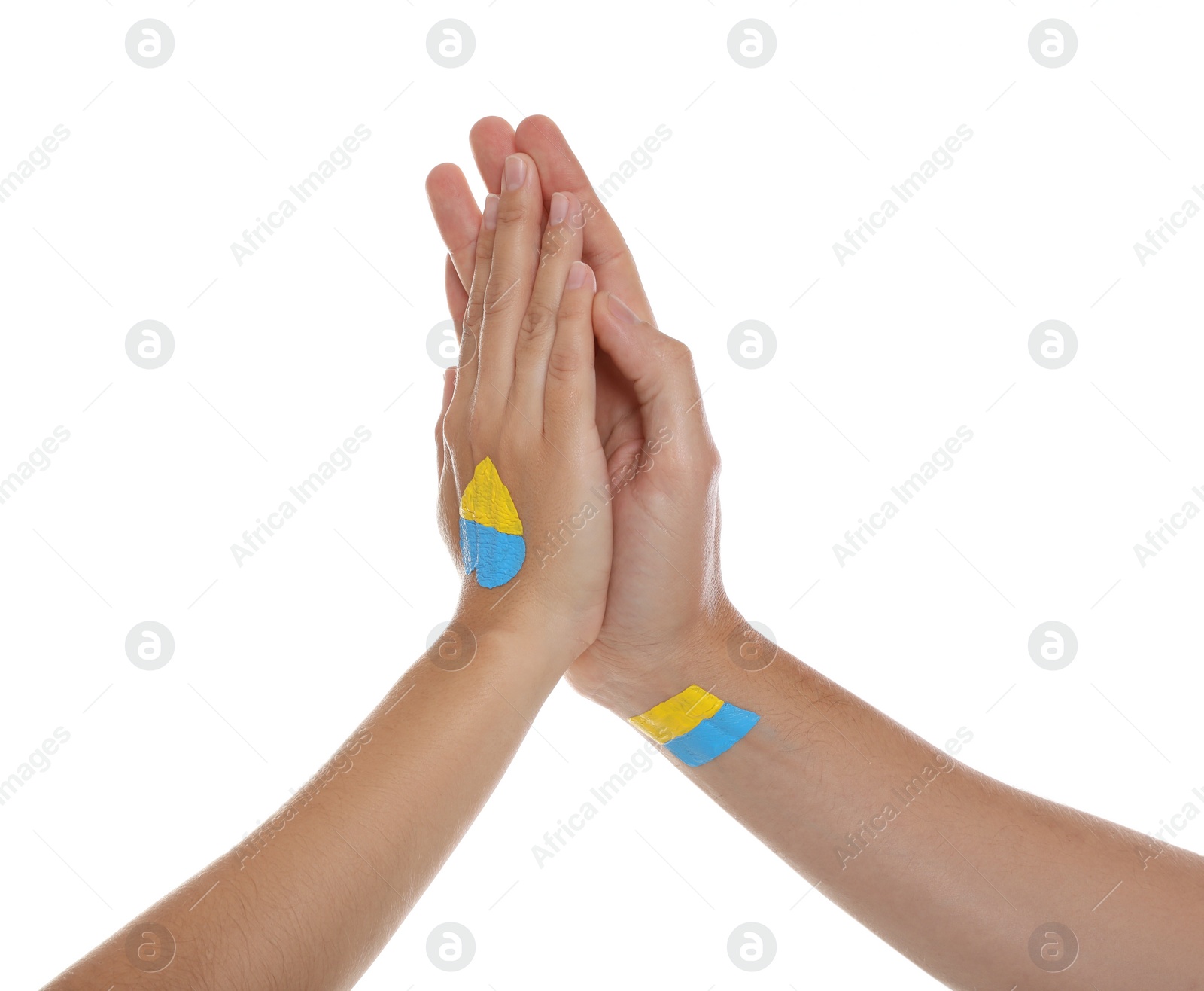 Photo of Man and woman with painted Ukrainian flags on their hands against white background, closeup