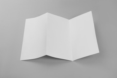 Photo of Blank paper brochure on light grey background. Mockup for design