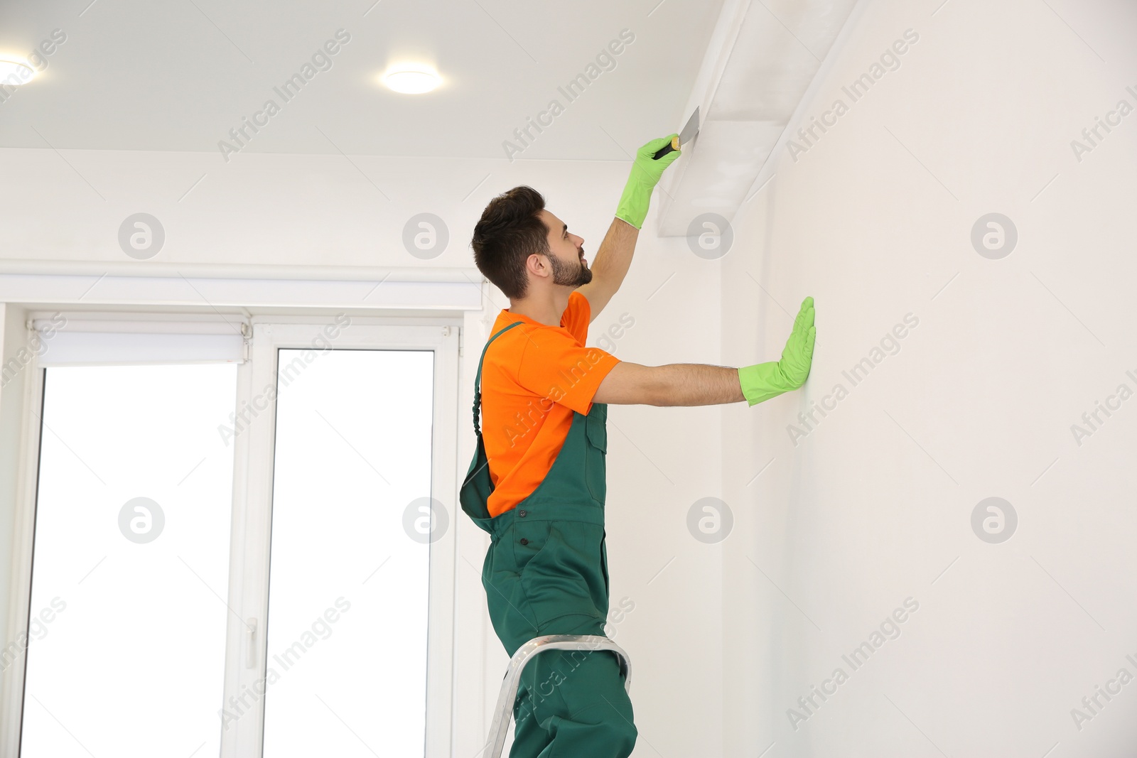 Photo of Professional young janitor in uniform. Cleaning service