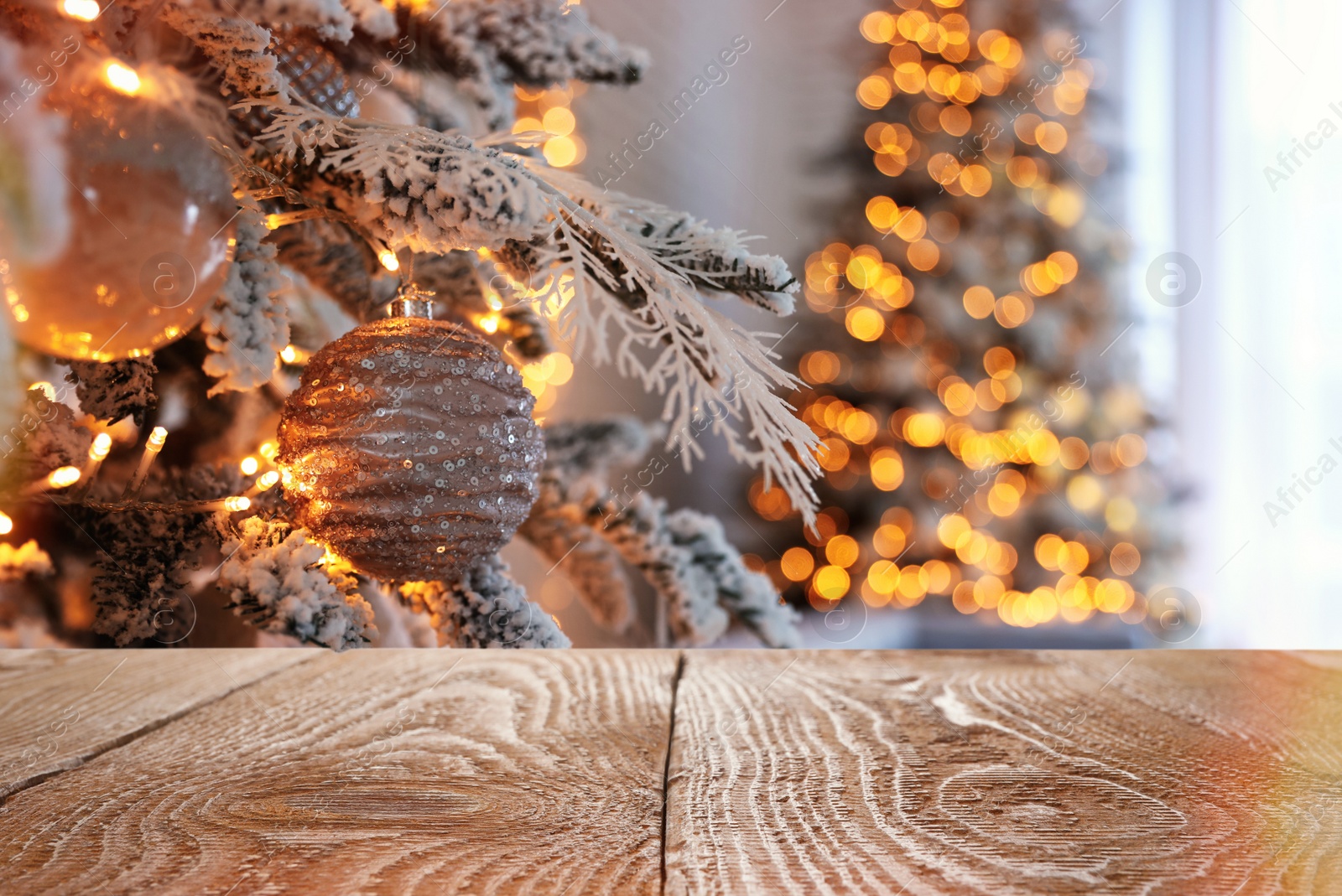 Image of Beautiful Christmas tree and wooden surface against blurred background