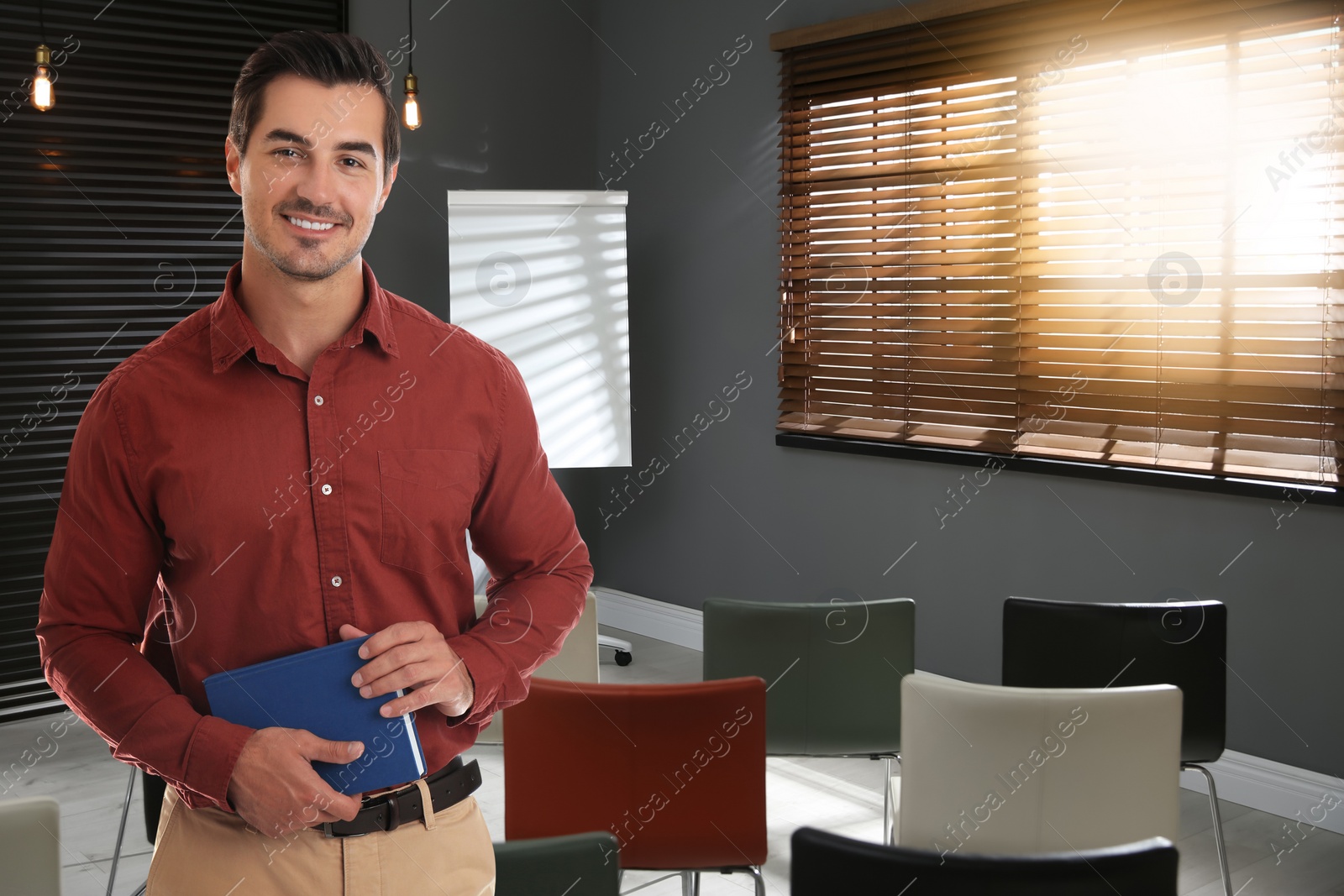 Image of Young teacher waiting for students in classroom