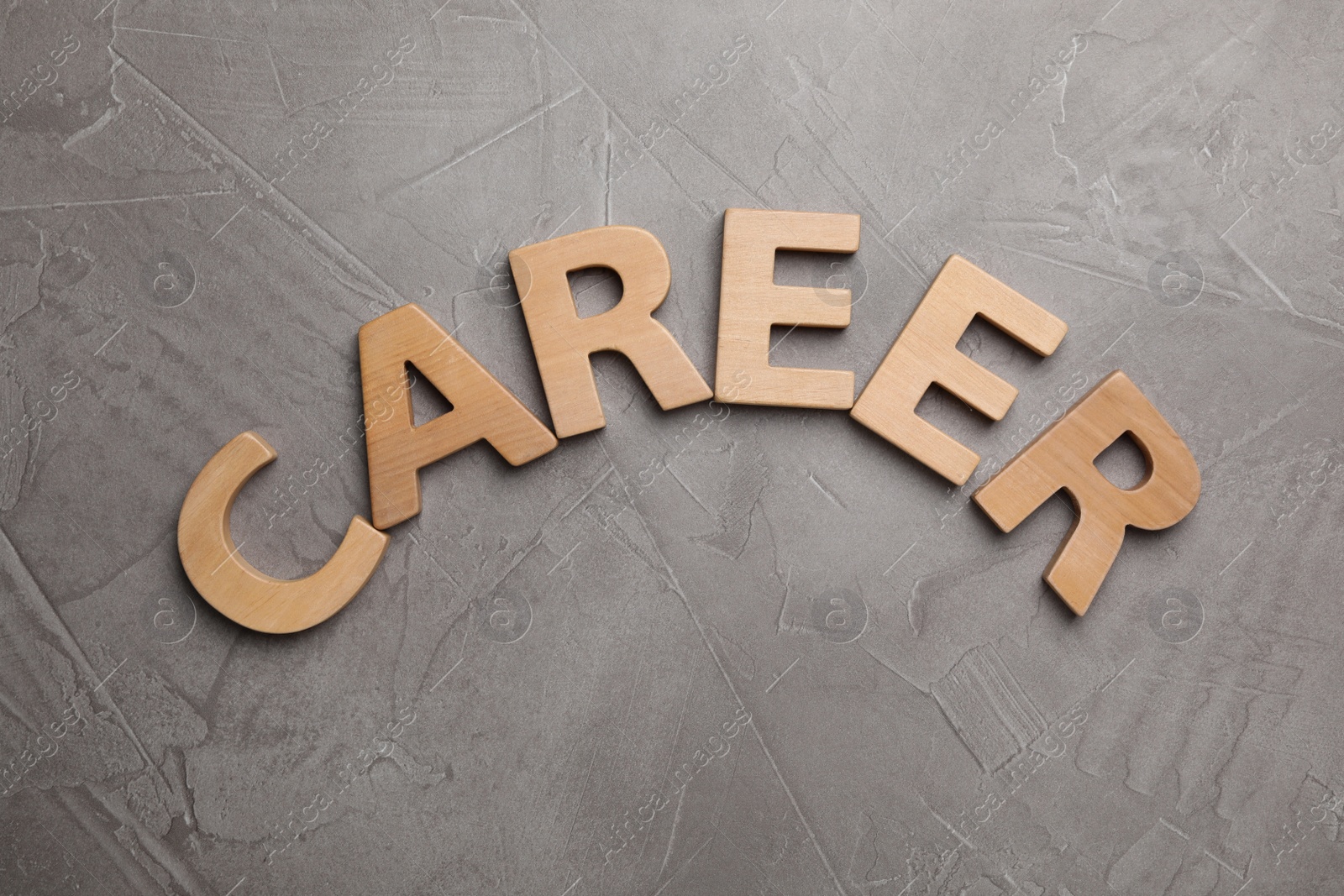 Photo of Word CAREER made with wooden letters on grey background, flat lay