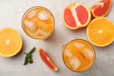 Photo of Delicious orange soda water on light table, flat lay