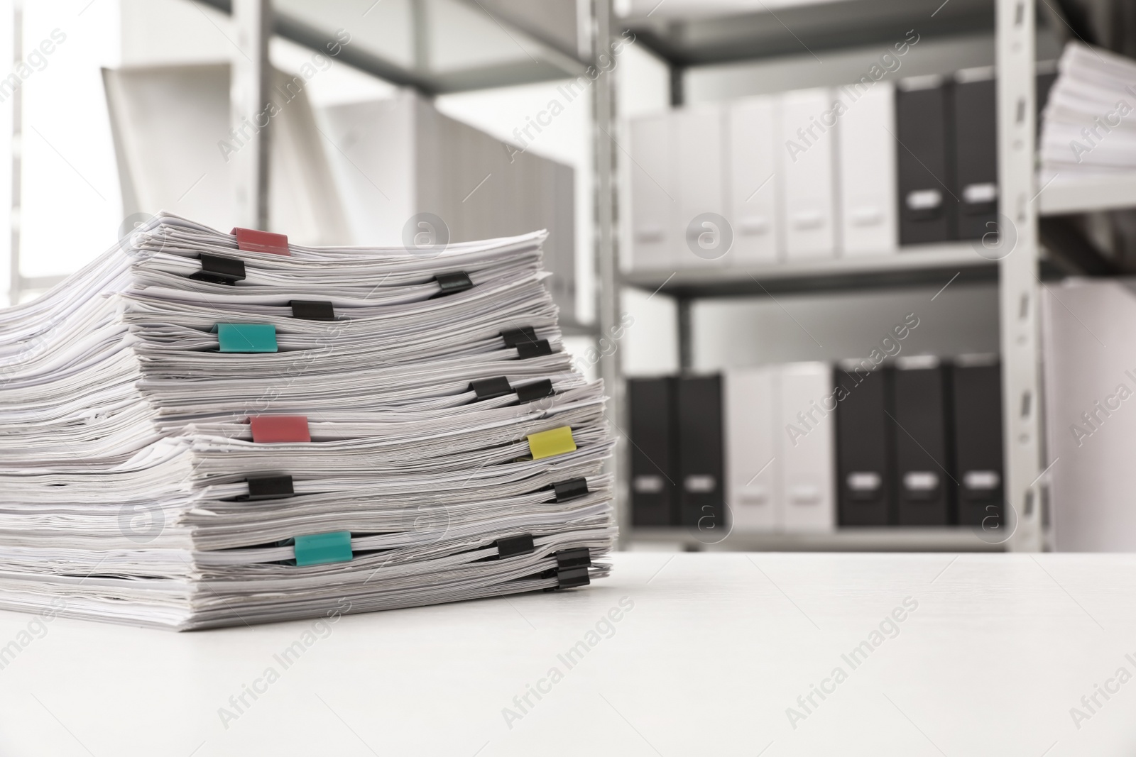 Photo of Stack of documents with paper clips on office desk. Space for text