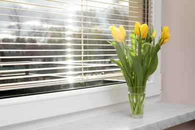 Photo of Wonderful tulips on window sill indoors, space for text. Spring atmosphere