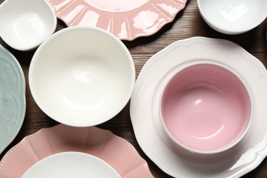 Photo of Beautiful ceramic dishware on wooden table, flat lay