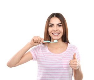 Photo of Beautiful woman brushing teeth on white background