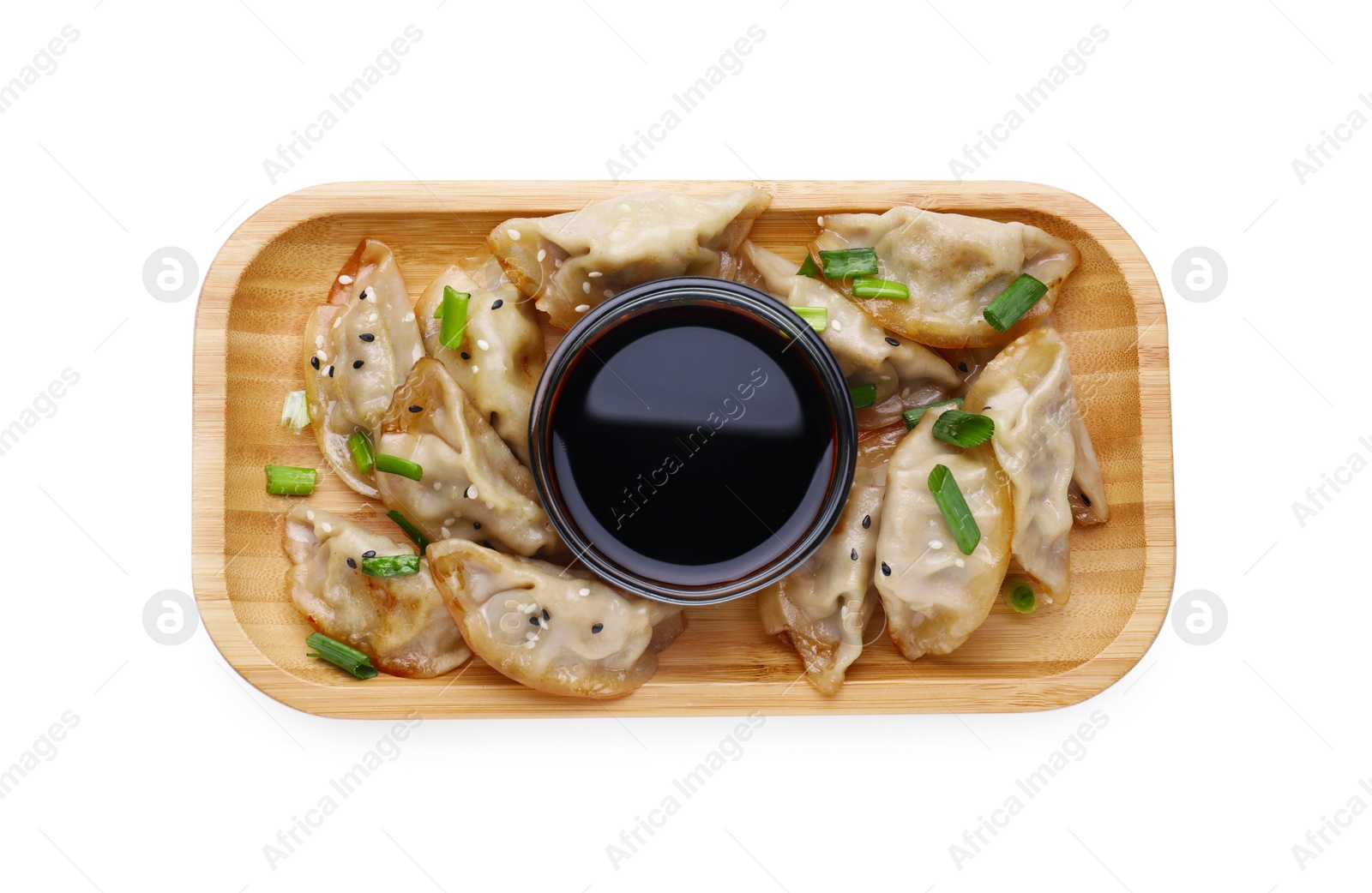 Photo of Delicious gyoza (asian dumplings) with green onions and soy sauce isolated on white, top view
