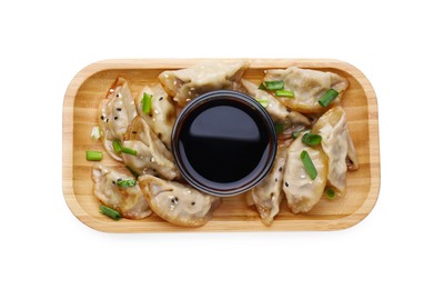 Photo of Delicious gyoza (asian dumplings) with green onions and soy sauce isolated on white, top view