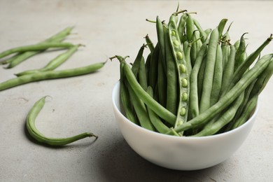 Photo of Fresh green beans on light grey table