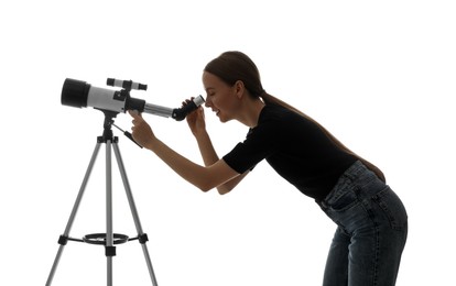 Young astronomer looking at stars through telescope on white background