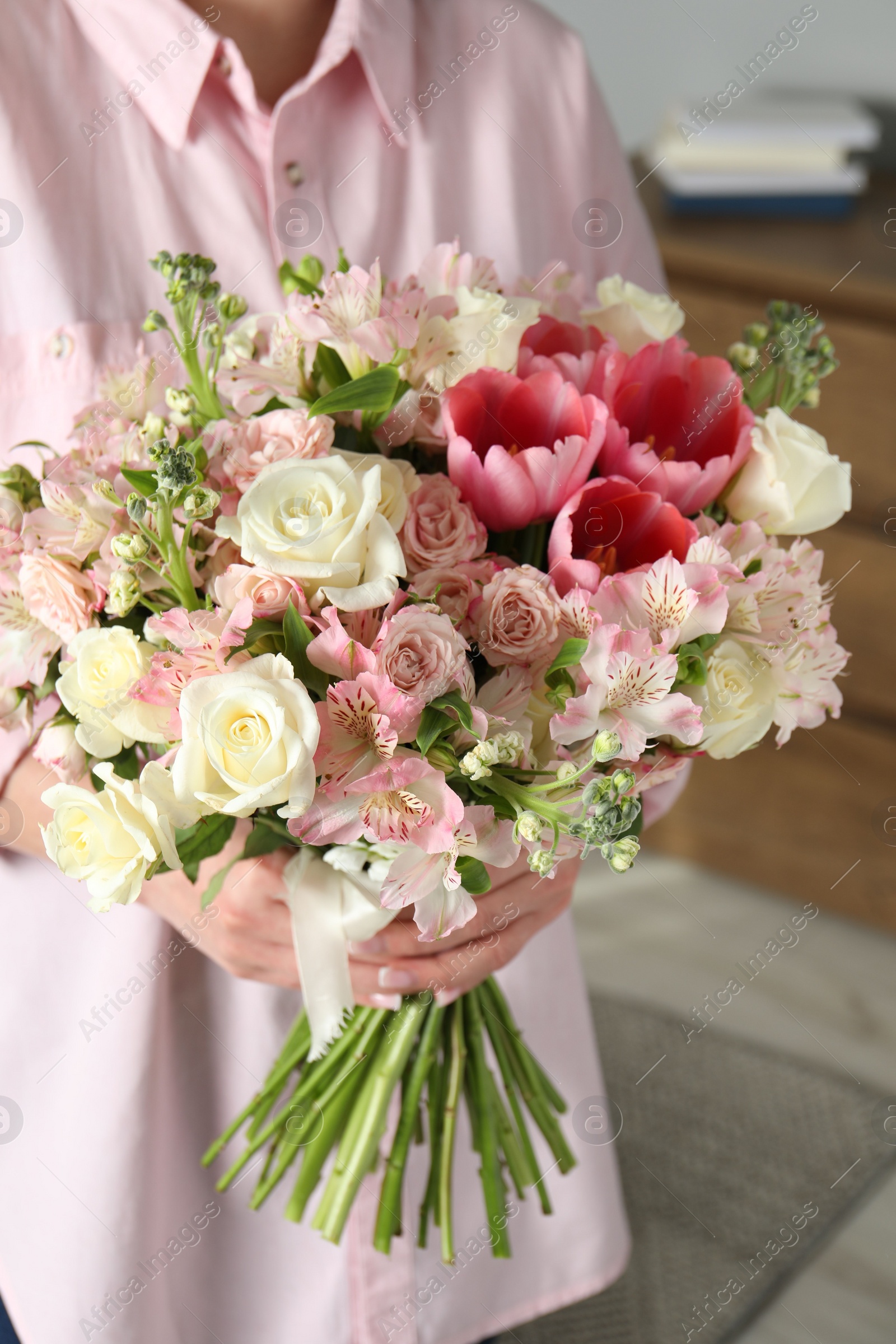 Photo of Woman with beautiful bouquet of fresh flowers indoors, closeup