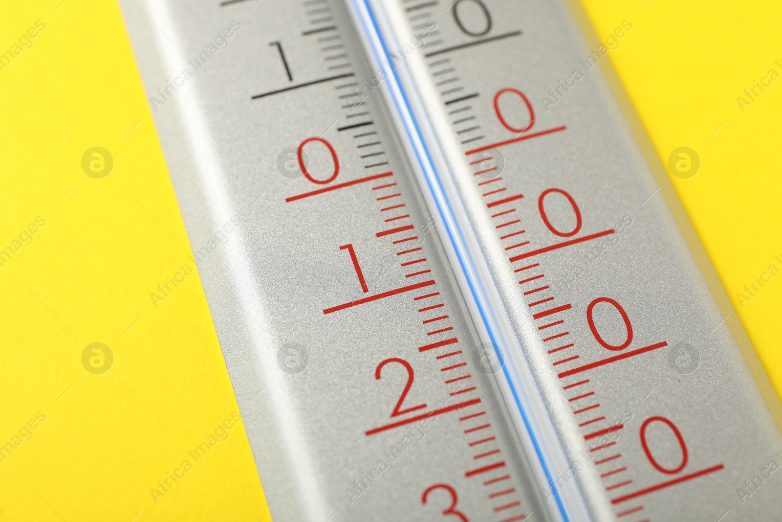 Photo of Modern weather thermometer on yellow background, closeup