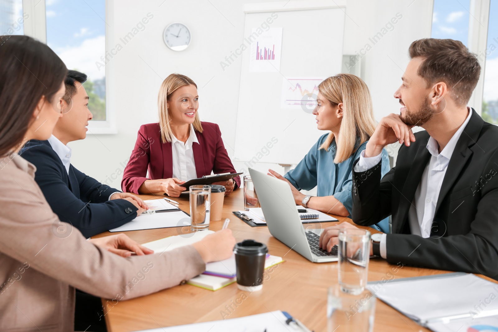 Photo of Businesswoman having meeting with her employees in office