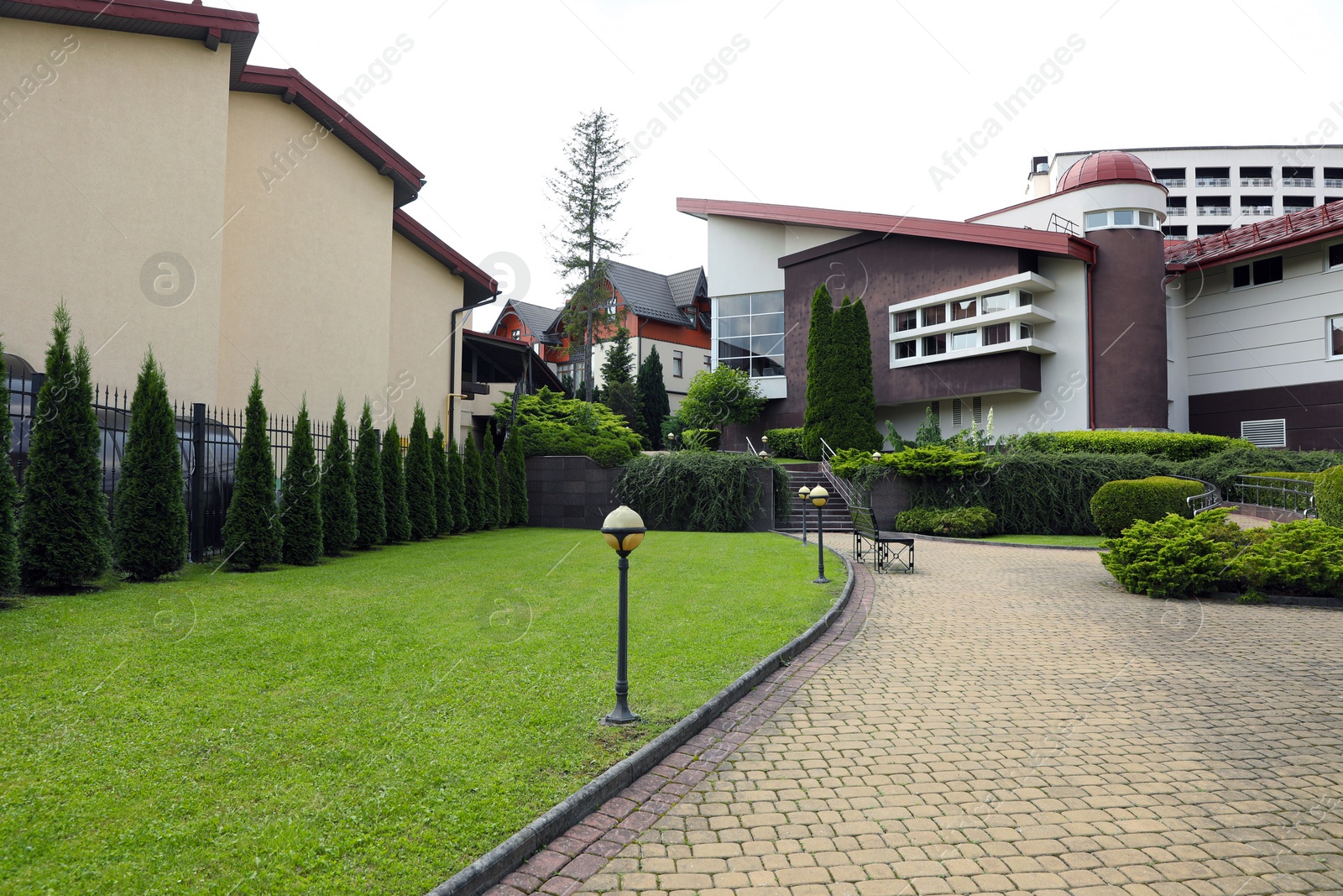 Photo of View of beautiful buildings and green plants in residential area. Landscape design