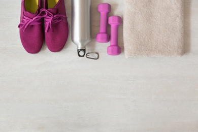 Photo of Flat lay composition with fitness equipment and space for text on gray background