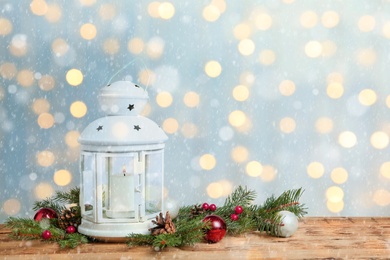 Composition with Christmas lantern on wooden table, space for text. Bokeh effect