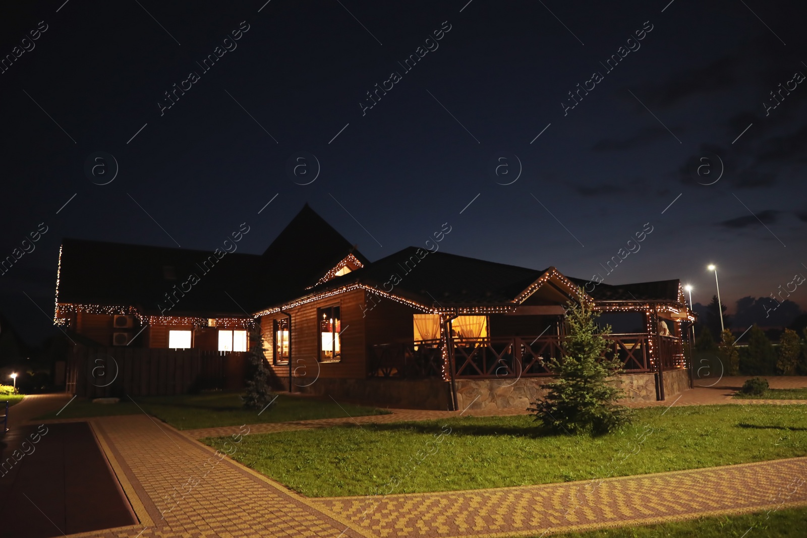 Photo of Beautiful view of house decorated with glowing lights