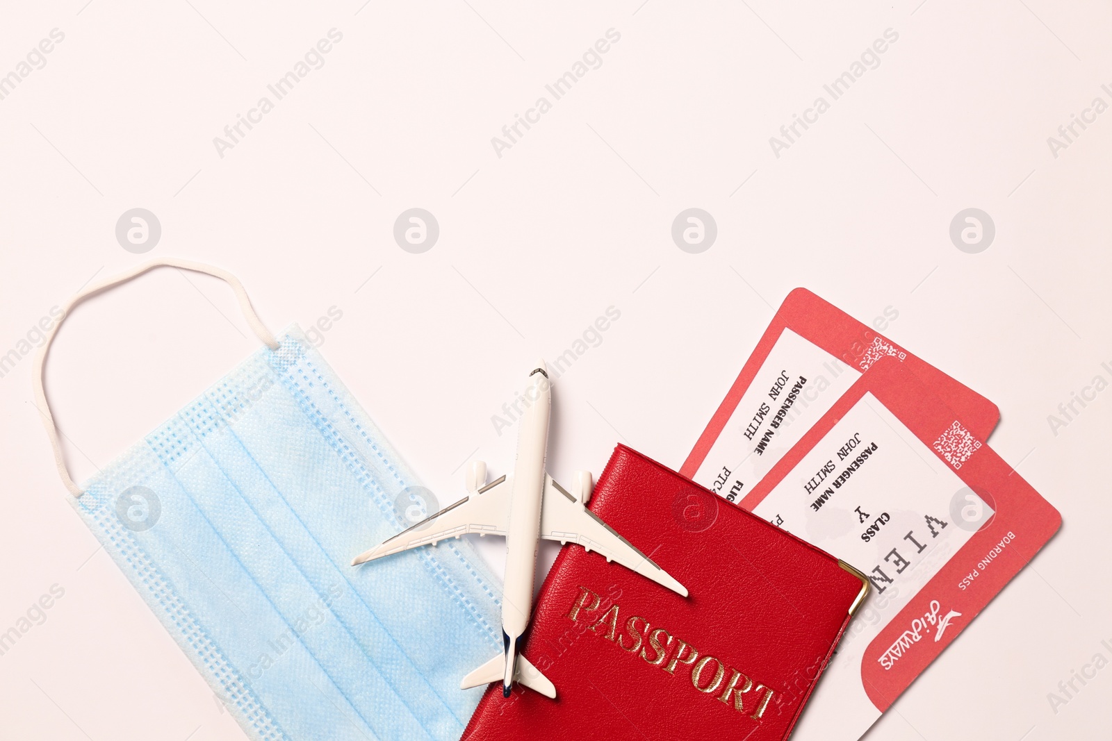 Photo of Composition with passport and protective mask on white background, top view. Travel during quarantine
