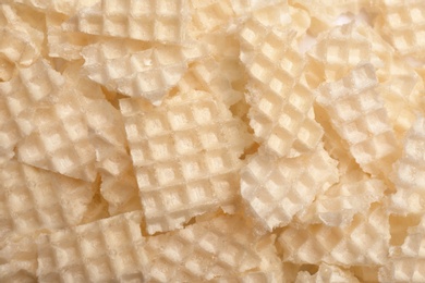 Photo of Tasty crushed wafers as background, closeup. Crispy food