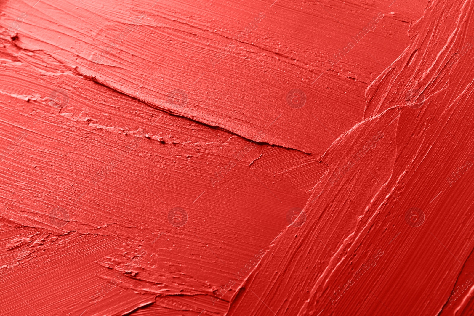 Photo of Red lipstick smears as background, closeup. Cosmetic product