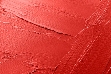 Photo of Red lipstick smears as background, closeup. Cosmetic product