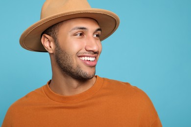 Portrait of happy African American man on light blue background