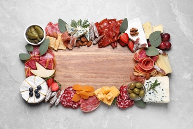Photo of Assorted appetizer served on light grey table, top view. Space for text