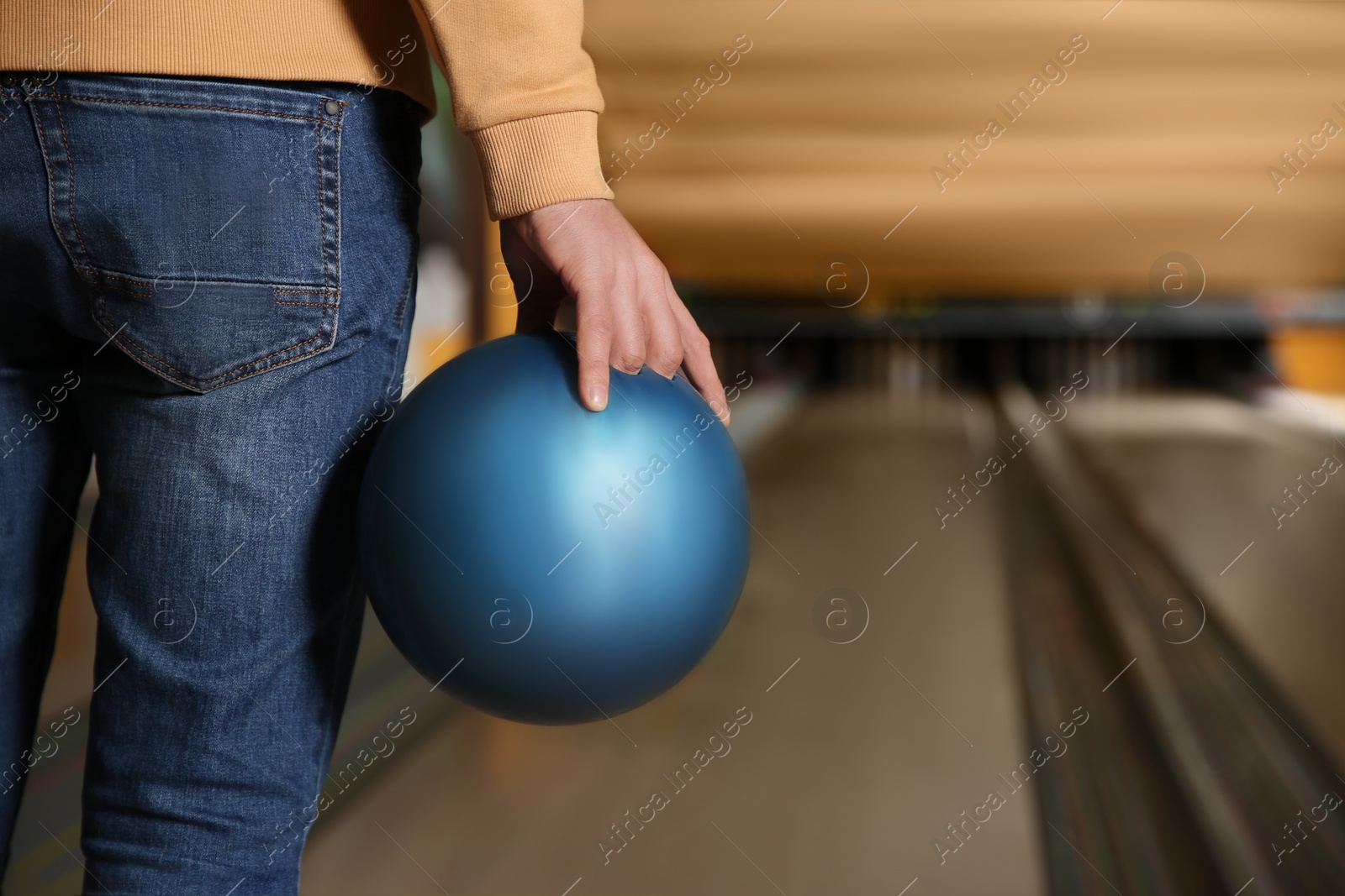 Photo of Man with ball in bowling club, closeup. Space for text