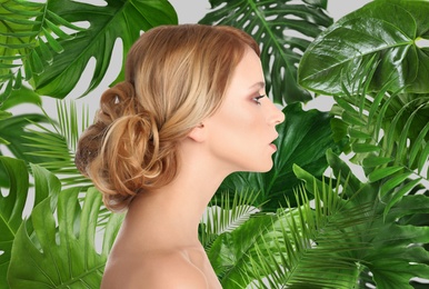 Image of Beautiful young woman and tropical leaves. Spa portrait