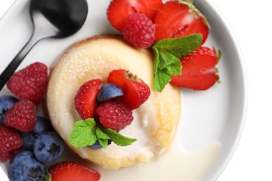 Photo of Delicious vanilla fondant served with fresh berries on grey table, top view