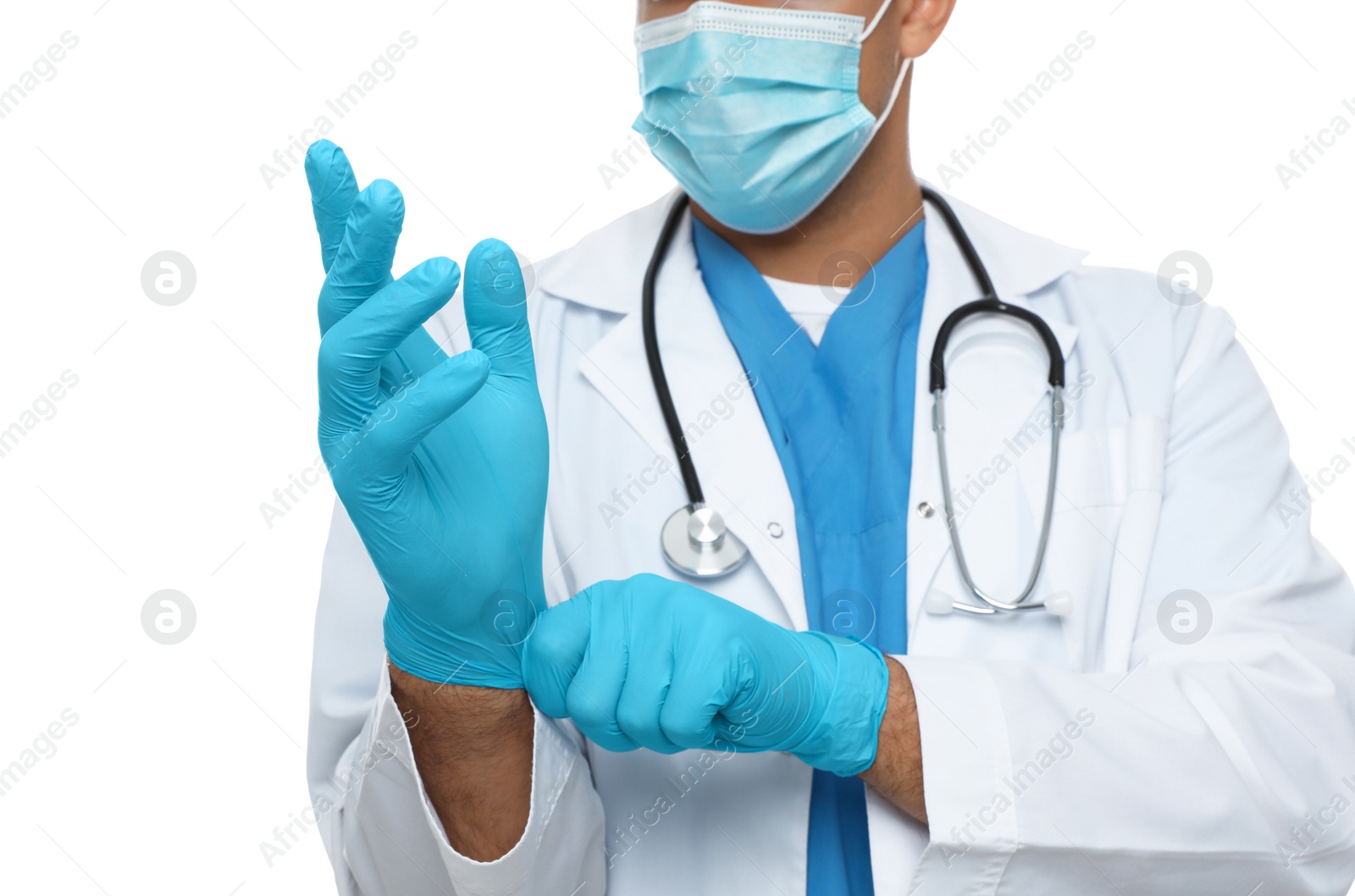 Photo of Doctor in protective mask putting on medical gloves against white background, closeup