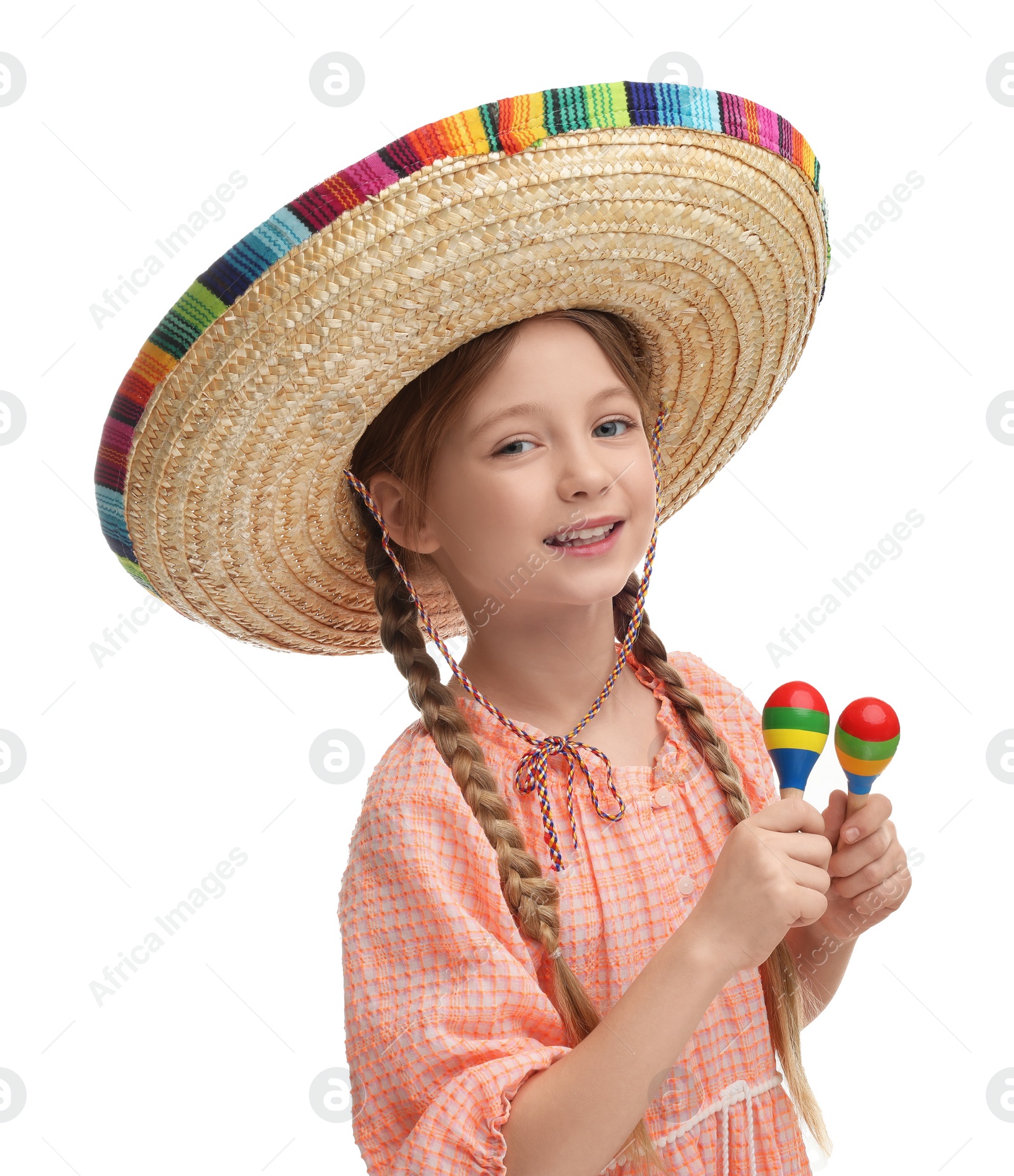 Photo of Cute girl in Mexican sombrero hat dancing with maracas on white background