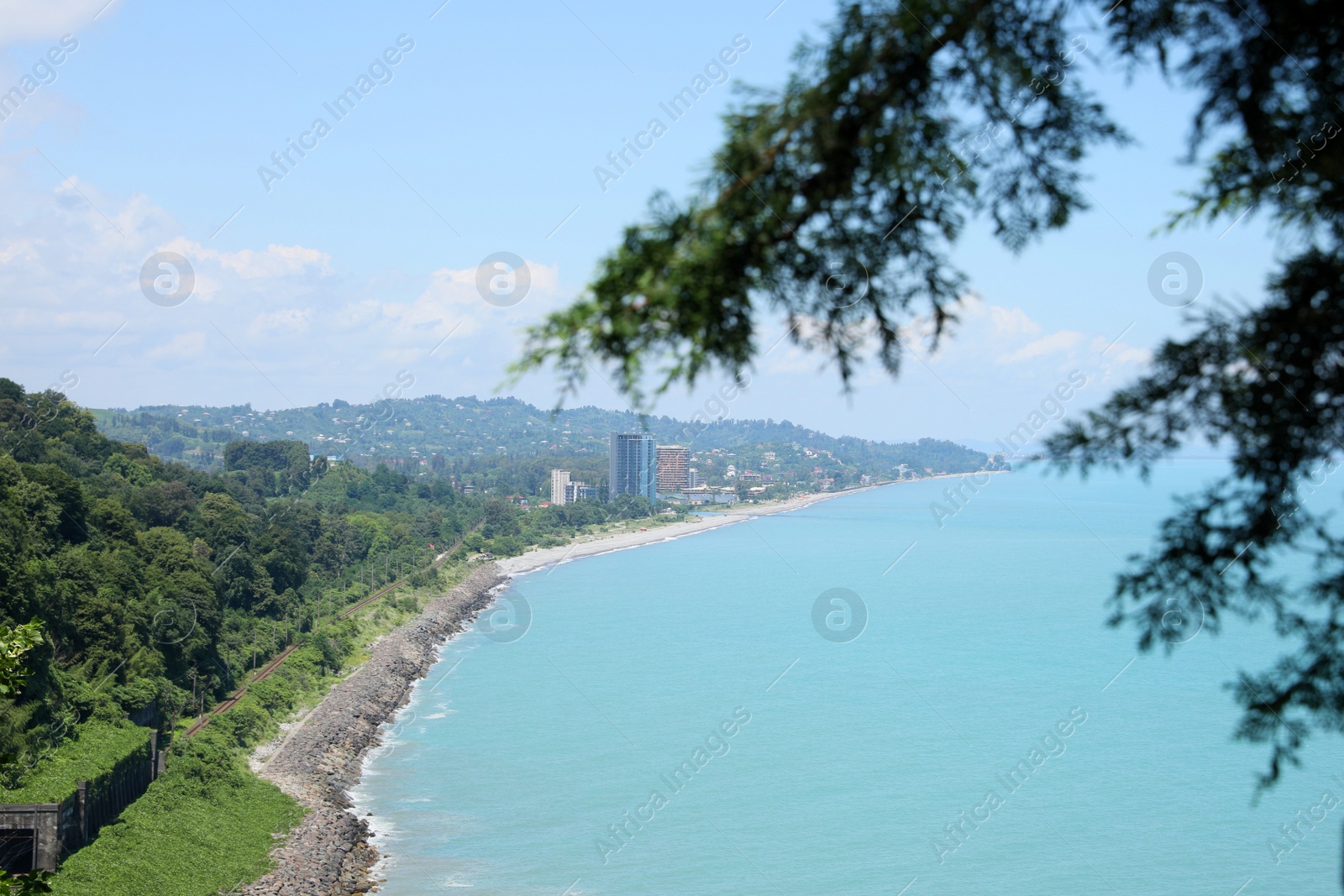 Photo of Picturesque view of distant city and beautiful sea on sunny day