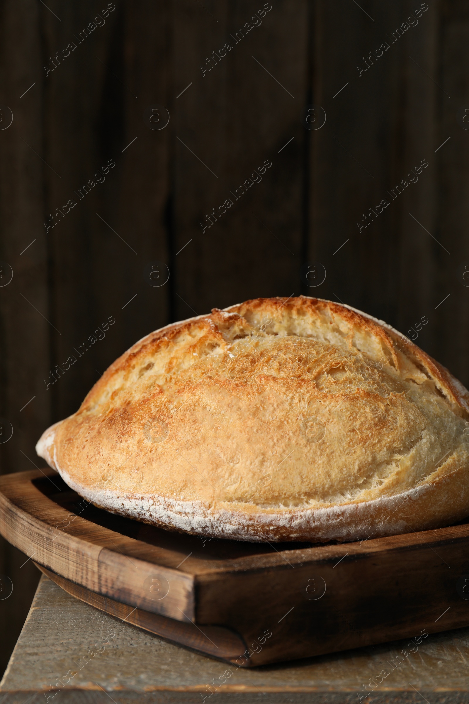 Photo of Freshly baked sourdough bread on wooden table