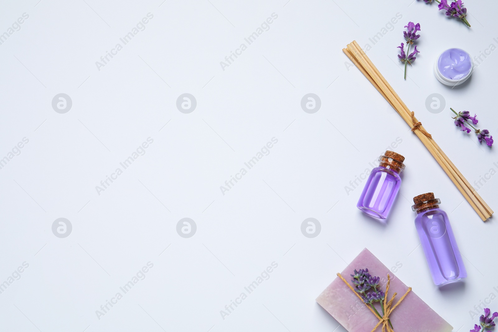 Photo of Cosmetic products and lavender flowers on white background, flat lay