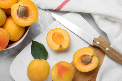 Photo of Delicious fresh ripe apricots on grey table, flat lay