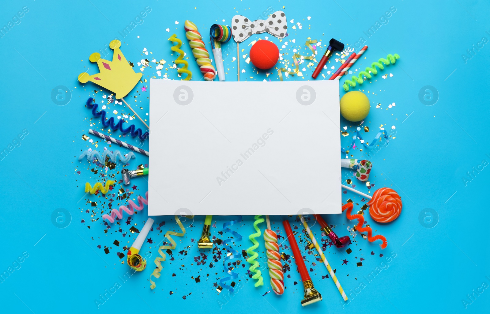 Photo of Frame of festive items on light blue background, flat lay with space for text. Surprise party concept