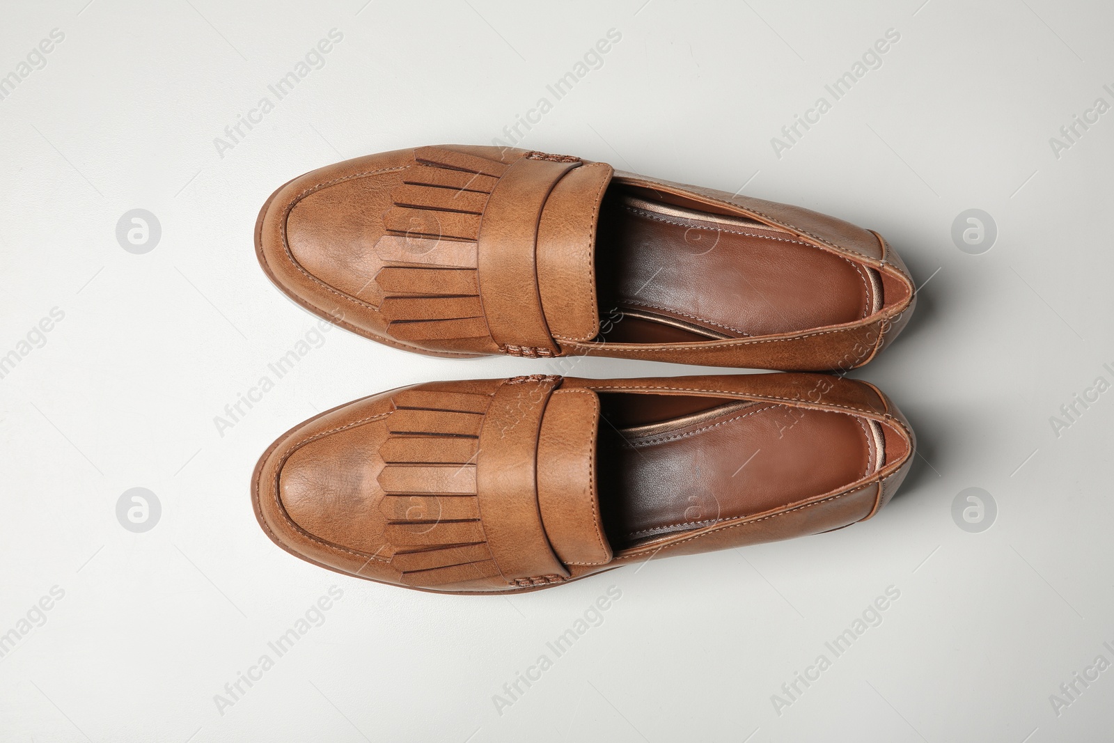 Photo of Pair of female shoes on white background