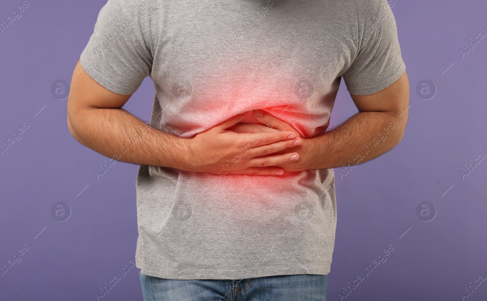 Image of Man suffering from stomach pain on purple background, closeup