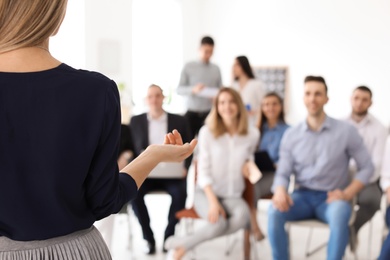 Photo of Female business trainer giving lecture in office