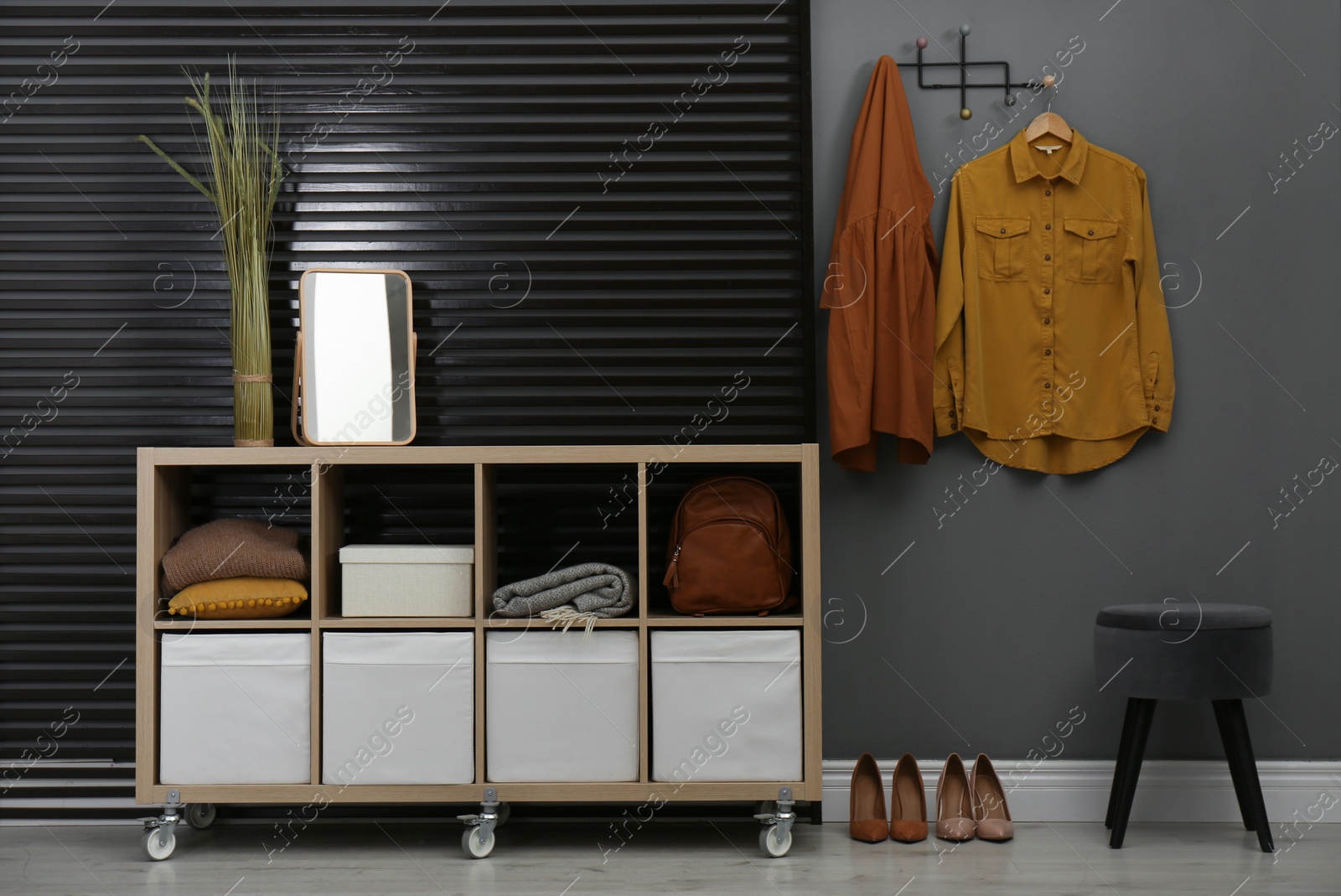 Photo of Hallway interior with stylish furniture, clothes and accessories