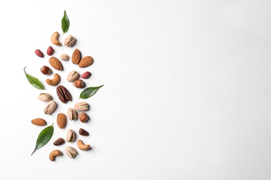 Photo of Composition with organic mixed nuts on white background, top view. Space for text