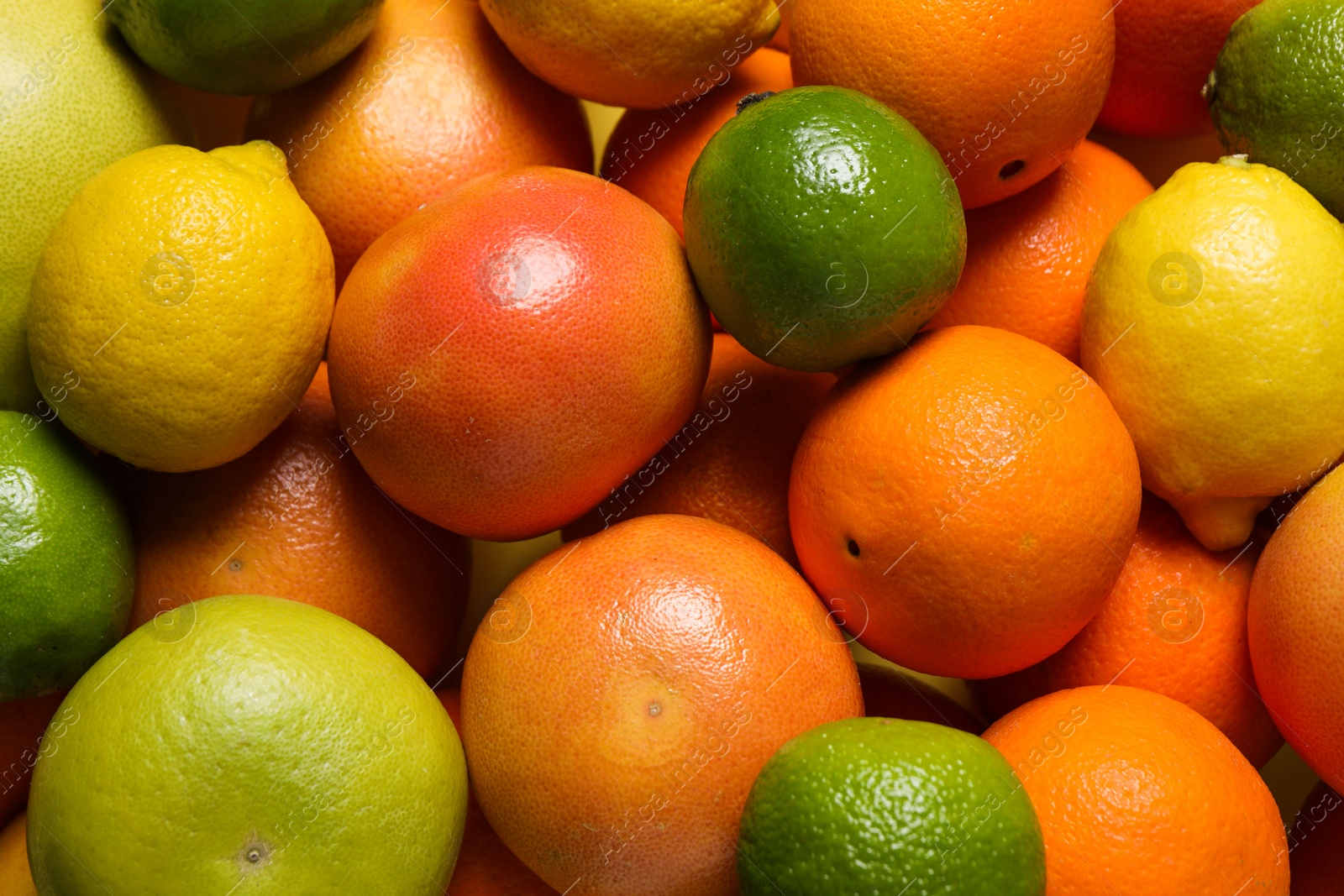 Photo of Different fresh citrus fruits as background, top view