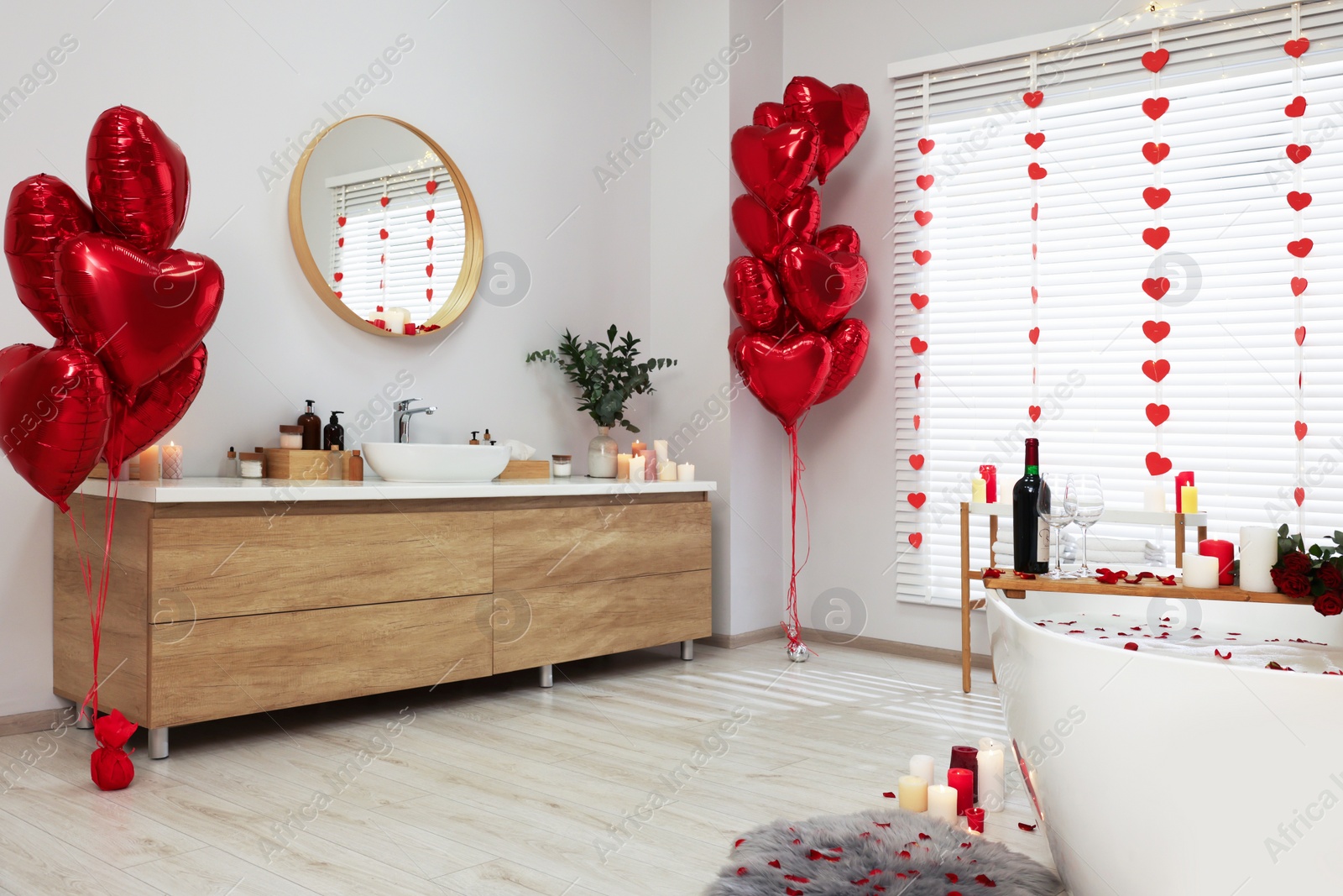 Photo of Stylish bathroom decorated for Valentine's day. Interior design