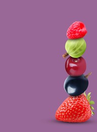 Stack of different fresh tasty berries and cherry on pale purple background, space for text