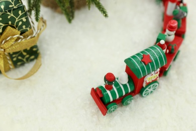 Bright toy train on artificial snow. Christmas atmosphere